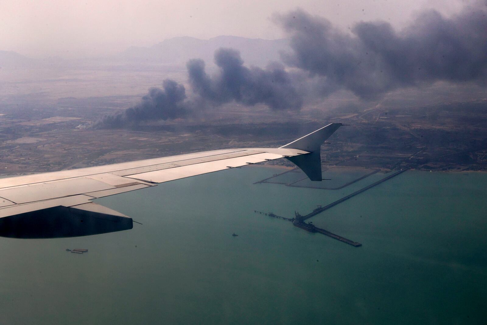 In this photo released by the Iranian Presidency Office, smoke rises in the sky on Sunday, April 27, 2025 after a massive explosion and fire rocked a port near the southern port city of Bandar Abbas, Iran, on Saturday. (Iranian Presidency Office via AP)