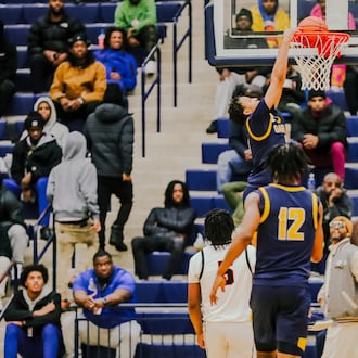 Garfield Heights junior Marcus Johnson dunks the ball during their game against Wayne at Flyin' to the Hoop showcase earlier this season. Michael Cooper/STAFF PHOTO