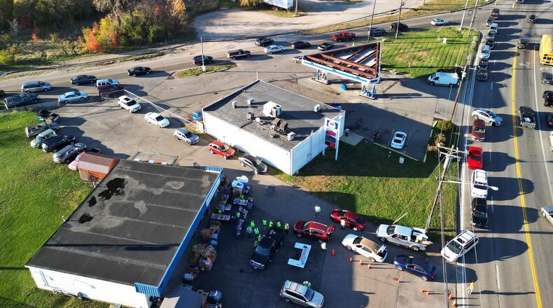Cars line up for food distribution Wednesday, Nov. 8 at Village Food Pantry in New Miami. The traffic when the pantry is open is consistently packed as people wait to receive items. NICK GRAHAM/STAFF