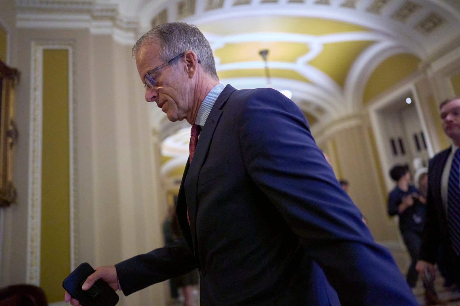 Senate Majority Leader John Thune, R-S.D., arrives at the chamber as Republican senators meet to find a way to help President Donald Trump cancel $9.4 billion in spending already approved by Congress, at the Capitol in Washington, Wednesday, June 11, 2025. (AP Photo/J. Scott Applewhite)