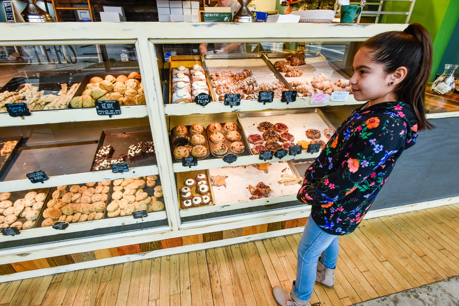 Reyanna Corona, 8, looks at baked goods at Almond Sisters Bakery on High Street in Hamilton Friday, April 5, 2019. Almond Sisters offers a variety of fresh baked desserts and pizza made on their own bread for lunch. NICK GRAHAM/STAFF