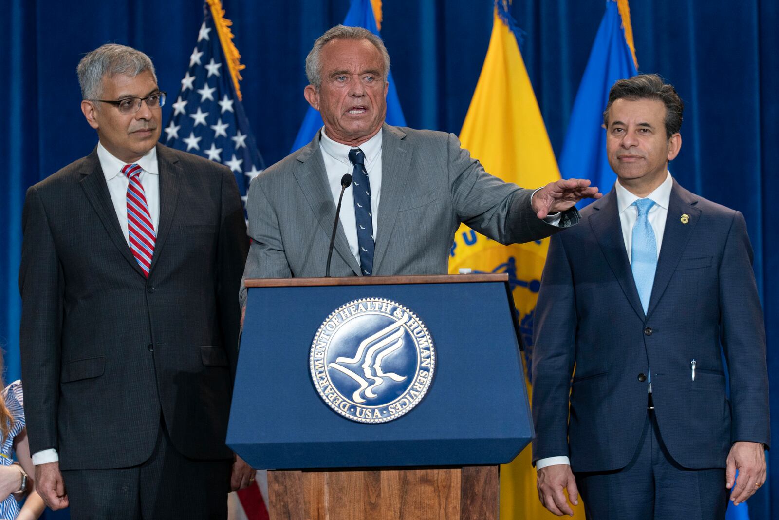 Health and Human Services Secretary Robert F. Kennedy Jr. flanked by Director of the National Institutes of Health Jay Bhattacharya, left, and Food and Drug Administration (FDA) Commissioner Marty Makary, right, speaks during a news conference on the FDA's intent to phase out the use of petroleum-based synthetic dyes in the nation's food supply at the Hubert Humphrey Building Auditorium in Washington, Tuesday, April 22, 2025. (AP Photo/Jose Luis Magana)