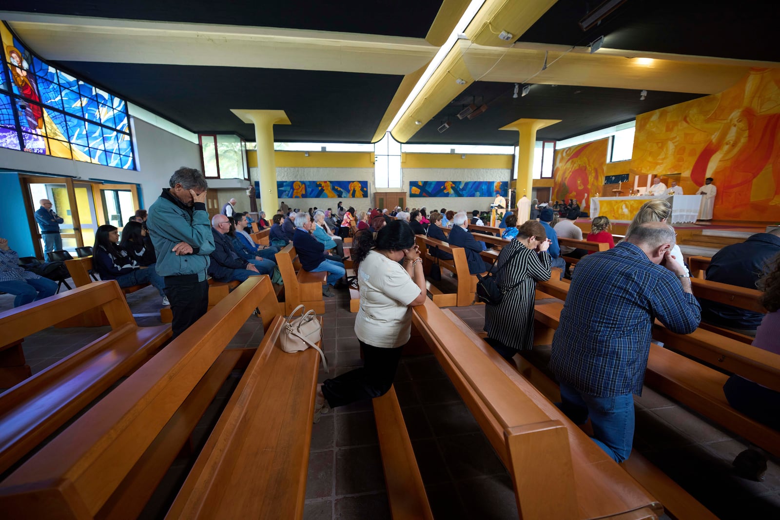 Faithful pray during a mass in San Paolo Della Croce parish church in Corviale neighbourhood, in Rome, Sunday, May 4, 2025. (AP Photo/Alessandra Tarantino)