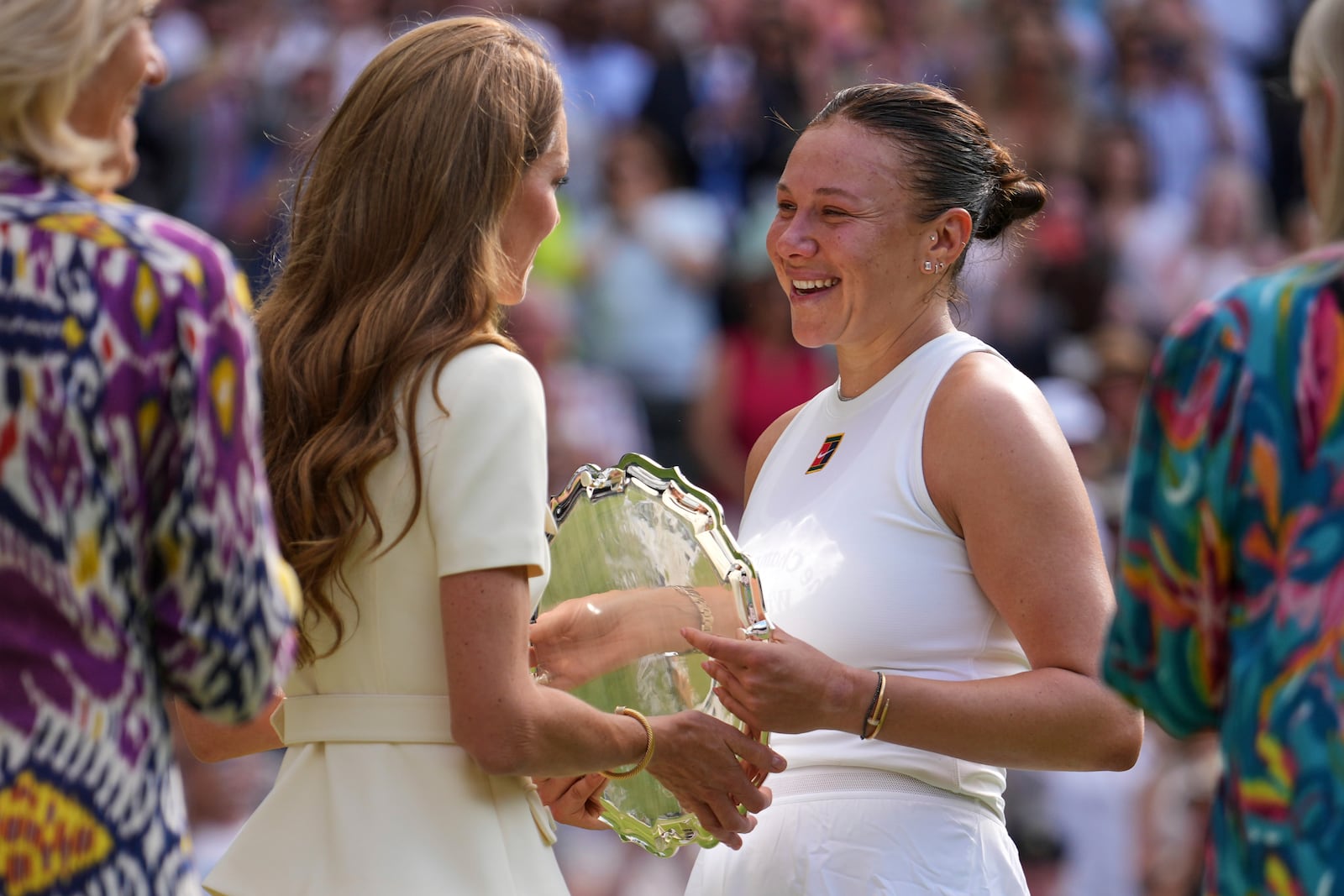 Amanda Anisimova of the U.S. receives her runners-up trophy from Kate, Princess of Wales, after losing to Poland's Iga Swiatek during the women's single final at the Wimbledon Tennis Championships in London, Saturday, July 12, 2025. (AP Photo/Kin Cheung)