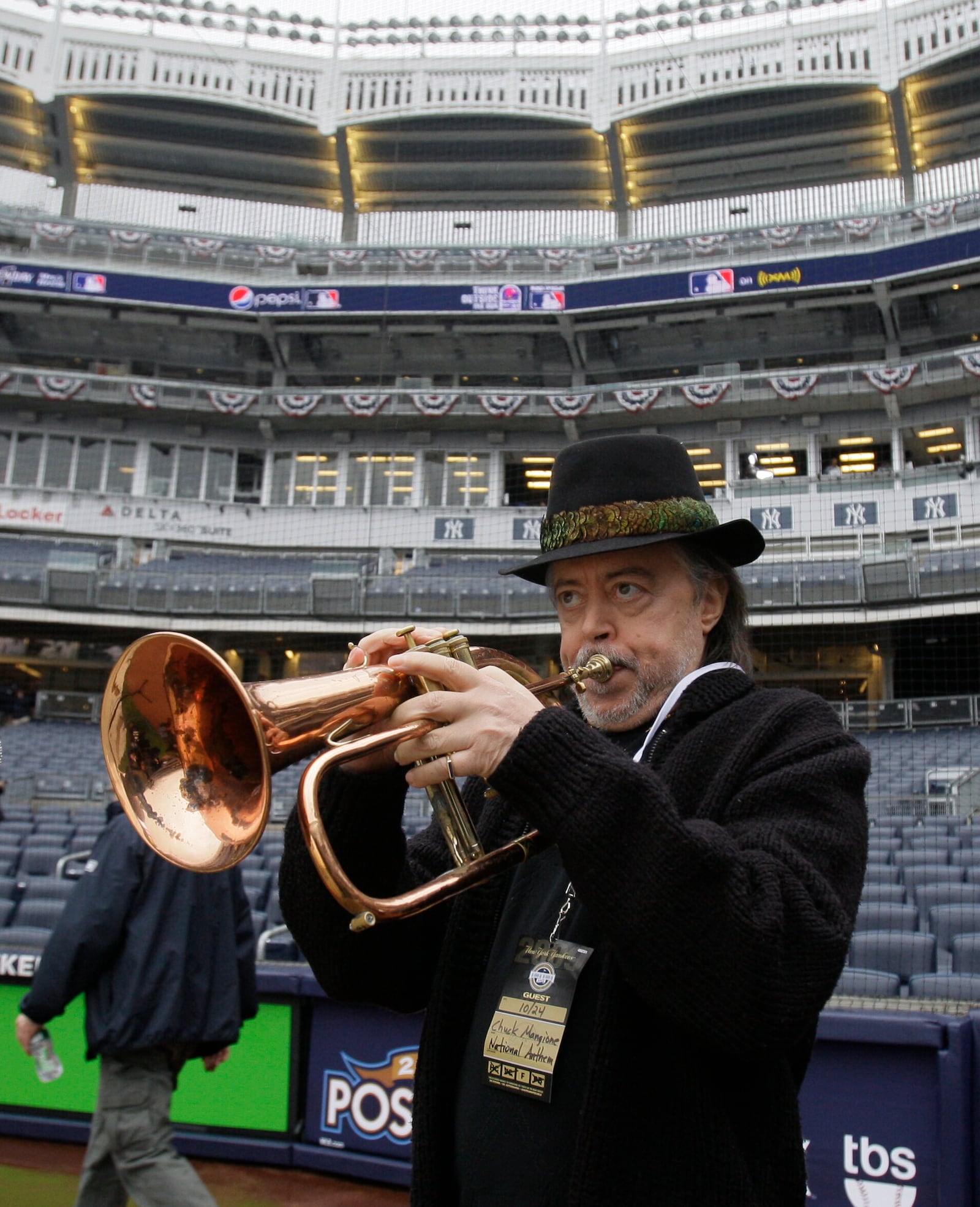 FILE - Flugelhorn player Chuck Mangione rehearses the national anthem before a baseball game between the Los Angeles Angels and New York Yankees, Oct. 24, 2009, in New York. (AP Photo/Elise Amendola, file)