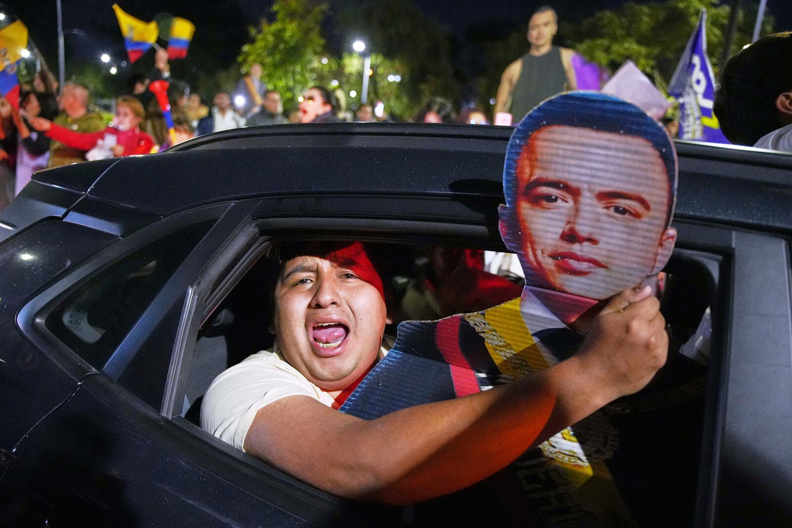 Supporters of President Daniel Noboa celebrate early returns showing him in the lead in the presidential election runoff in Quito, Ecuador, Sunday, April 13, 2025. (AP Photo/Carlos Noriega)