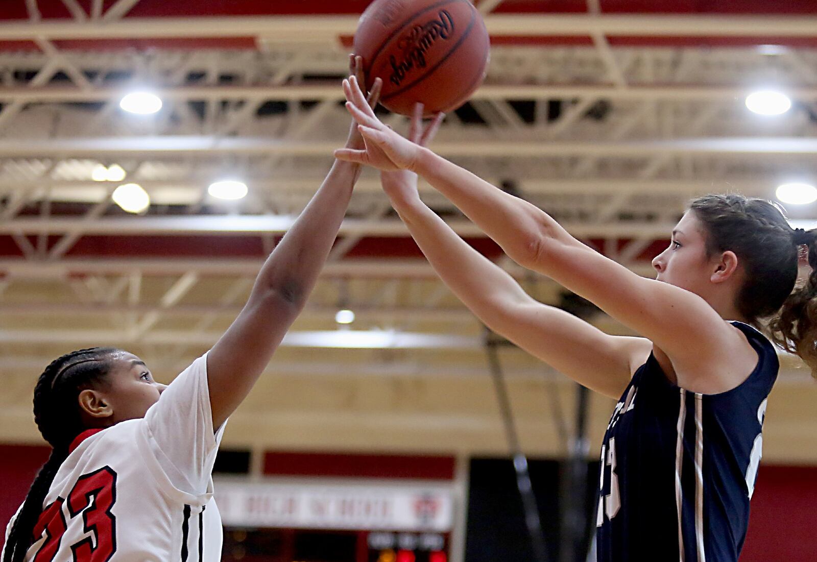 Mt. Healthy’s Ebony Johnson blocks the shot of Edgewood forward Sara Schaefer on Saturday afternoon at Mt. Healthy. CONTRIBUTED PHOTO BY E.L. HUBBARD