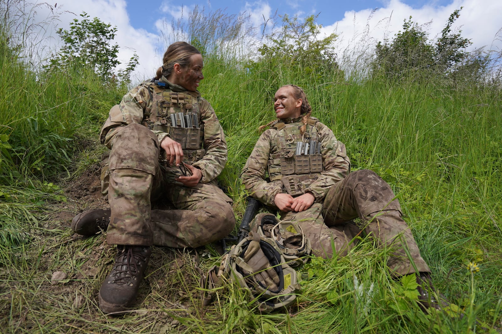 20-year-old conscript Katrine, right, speaks with another female conscript during final exercises at a training area close to Royal Danish Army’s barracks in Hovelte, 25 kilometres north of Copenhagen, Denmark, Wednesday, June 11, 2025. (AP Photo/James Brooks)