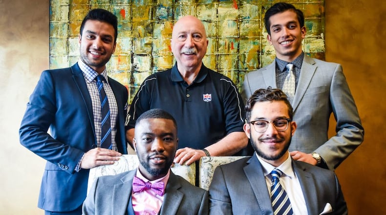 Greg Ossmann (back row, middle), the executive director of the National Football League’s Players Association in Cincinnati, mentors four men from Butler County as they grow into their professional careers. The four are all founders of Civility International, which teaches civility to local youth and rewards civil acts.