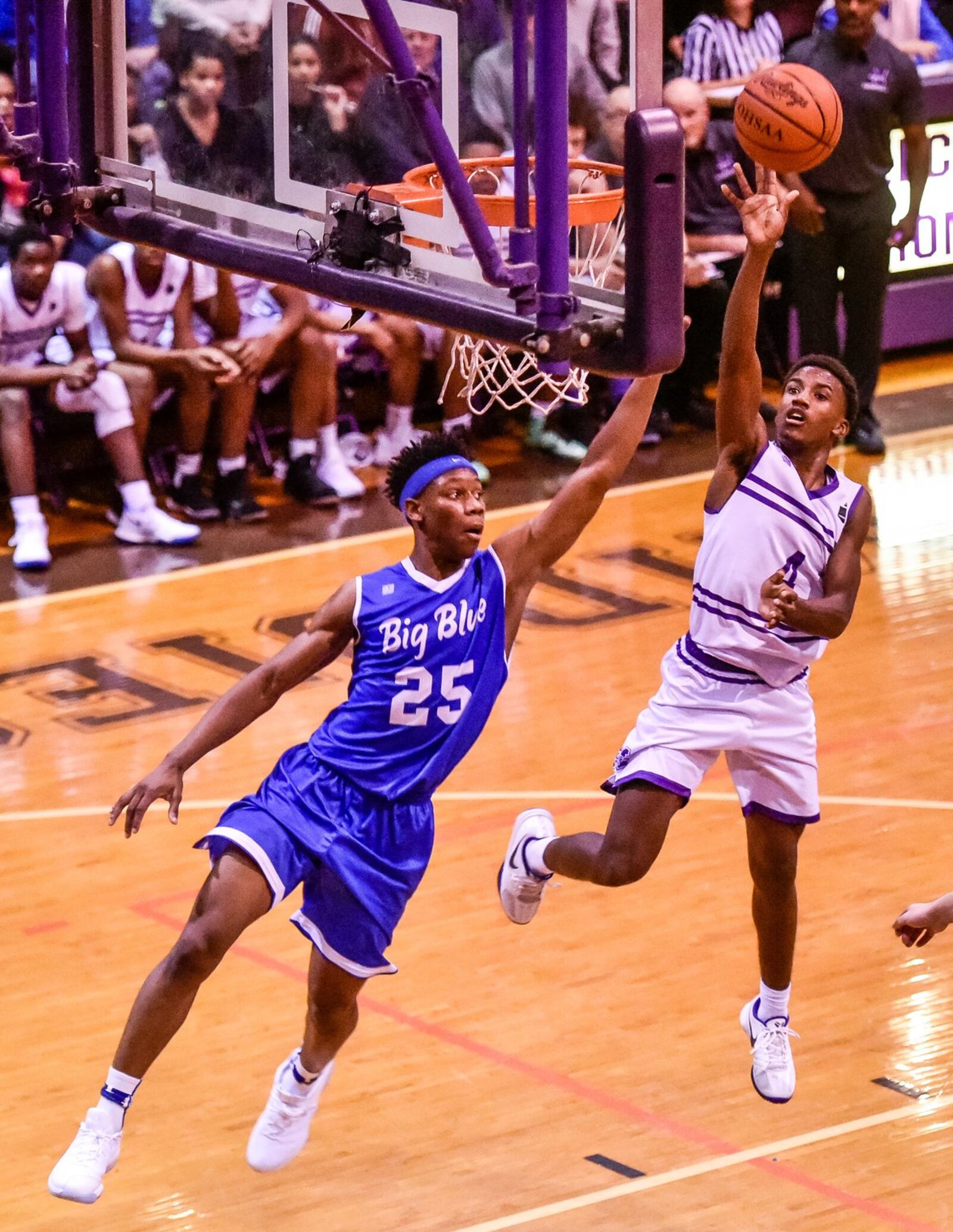 Middletown’s Aaron Jones puts up a shot over Hamilton’s D’Marco Howard on Friday night at Wade E. Miller Gym in Middletown. NICK GRAHAM/STAFF