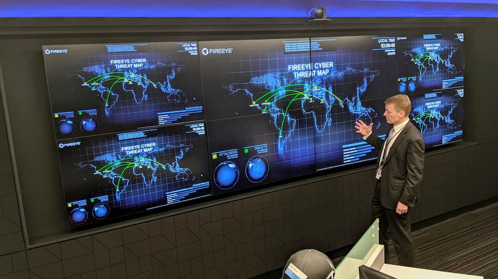 FILE - The CEO of FireEye Kevin Mandia gives a tour of the cybersecurity company's unused office space in Reston, Va., March 9, 2021. (AP Photo/Nathan Ellgren, file)