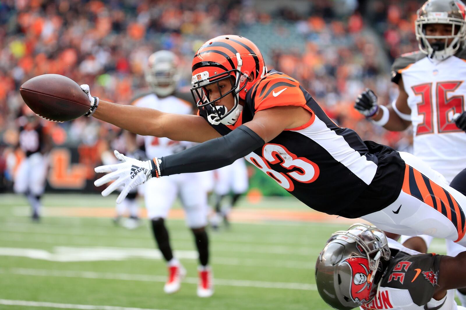 CINCINNATI, OH - OCTOBER 28: Tyler Boyd #83 of the Cincinnati Bengals dives over Isaiah Johnson #39 of the Tampa Bay Buccaneers in an attempt to reach the end zone during the first quarter at Paul Brown Stadium on October 28, 2018 in Cincinnati, Ohio. Boyd was knocked out of bounds just short of the goal line. (Photo by Andy Lyons/Getty Images) *** BESTPIX ***