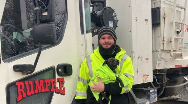 Rumpke driver Aaron Kinsel adopted "Tipper," a 10-week-old puppy he found abandoned inside a backpack along a Colerain Township road. PROVIDED