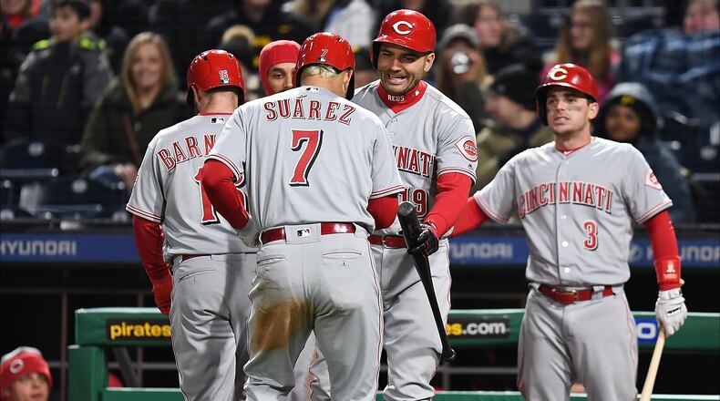 PITTSBURGH, PA - APRIL 07:  Eugenio Suarez #7 of the Cincinnati Reds celebrates with teammates after hitting a three run home run during the eighth inning against the Pittsburgh Pirates at PNC Park on April 7, 2018 in Pittsburgh, Pennsylvania. (Photo by Joe Sargent/Getty Images)