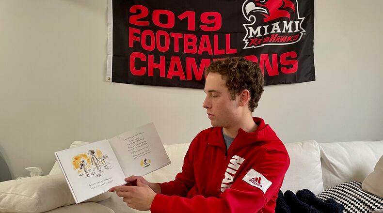 Miami University football player Henry Beckett invented a new reading program involving himself and other university athletes to reach out to students in the adjacent Talawanda School system. Beckett, shown here during one of his video recordings of reading remotely to school kids, plans to recruit more Miami athletes to become regular members of his "Redhawk Readers." (Provided Photo\Journal-News)
