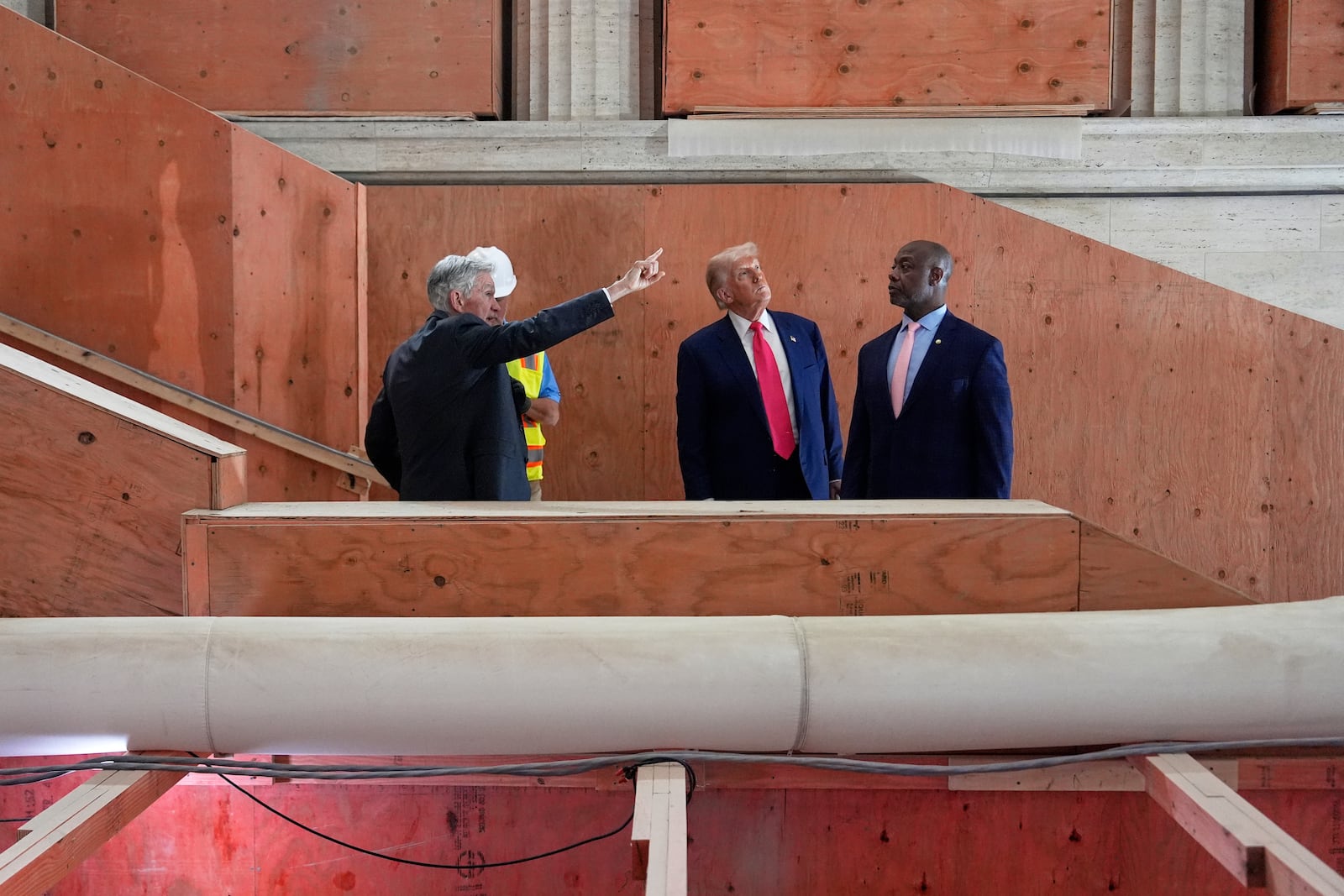 Federal Reserve Chairman Jerome Powell, from left, President Donald Trump and Sen. Tim Scott, R-S.C., visit the Federal Reserve, Thursday, July 24, 2025, in Washington. (AP Photo/Julia Demaree Nikhinson)