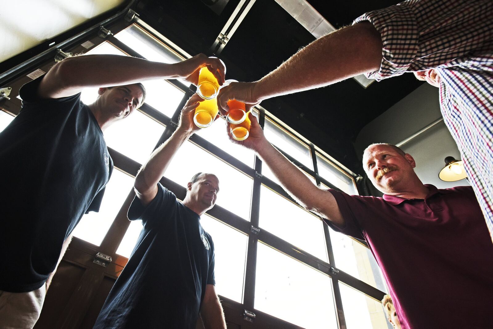 For the third time, Hamilton’s Municipal Brew Works again will tap its special Woltermelon Blonde Ale to honor fallen firefighter Patrick Wolterman. A ceremonial first pour and toast is set for Aug. 2. Pictured are friends are family of Wolterman during the beer’s 2016 limited release. NICK GRAHAM/FILE (2016)