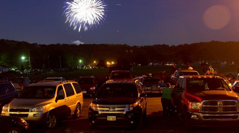 Spectators watch from Fairfield West Baptist Church as Rozzi’s Famous Fireworks fill the sky in Fairfield during the Red White and Kaboom celebration, Friday, July 3, 2014. GREG LYNCH / STAFF