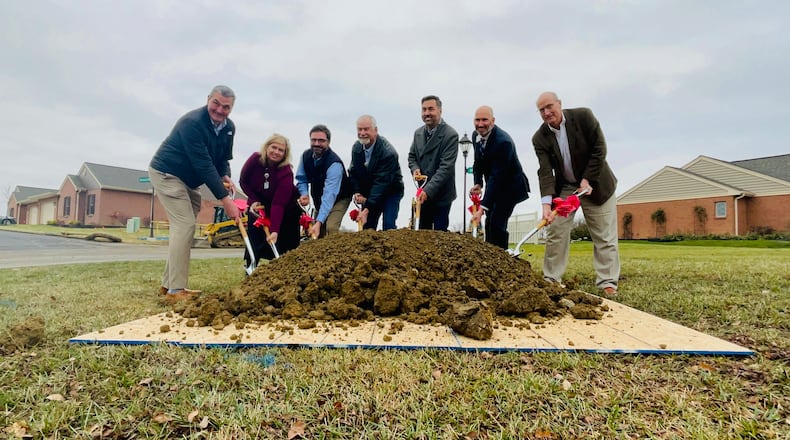 Officials with the city of Hamilton and Berkeley Square pose for a ceremonial groundbreaking photo as the senior living facility embarks on its 15th expansion phase. MICHAEL D. PITMAN/STAFF