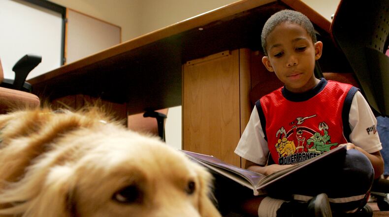 Warren Bess, 8, of Colerain Twp., reads to Hitch, the registered therapy dog of Rebecca Townsend, at the Fairfield Lane Library Thursday, September 10, 2009. CONTRIBUTED BY E.L. HUBBARD