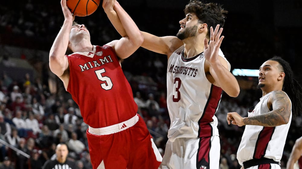 Miami Ohio guard Peter Suder (5) is fouled by UMass forward Leonardo Bettiol (3) in the second half of an NCAA college basketball game, Tuesday, Feb. 17, 2026, in Amherst, Mass. (AP Photo/Jessica Hill)
