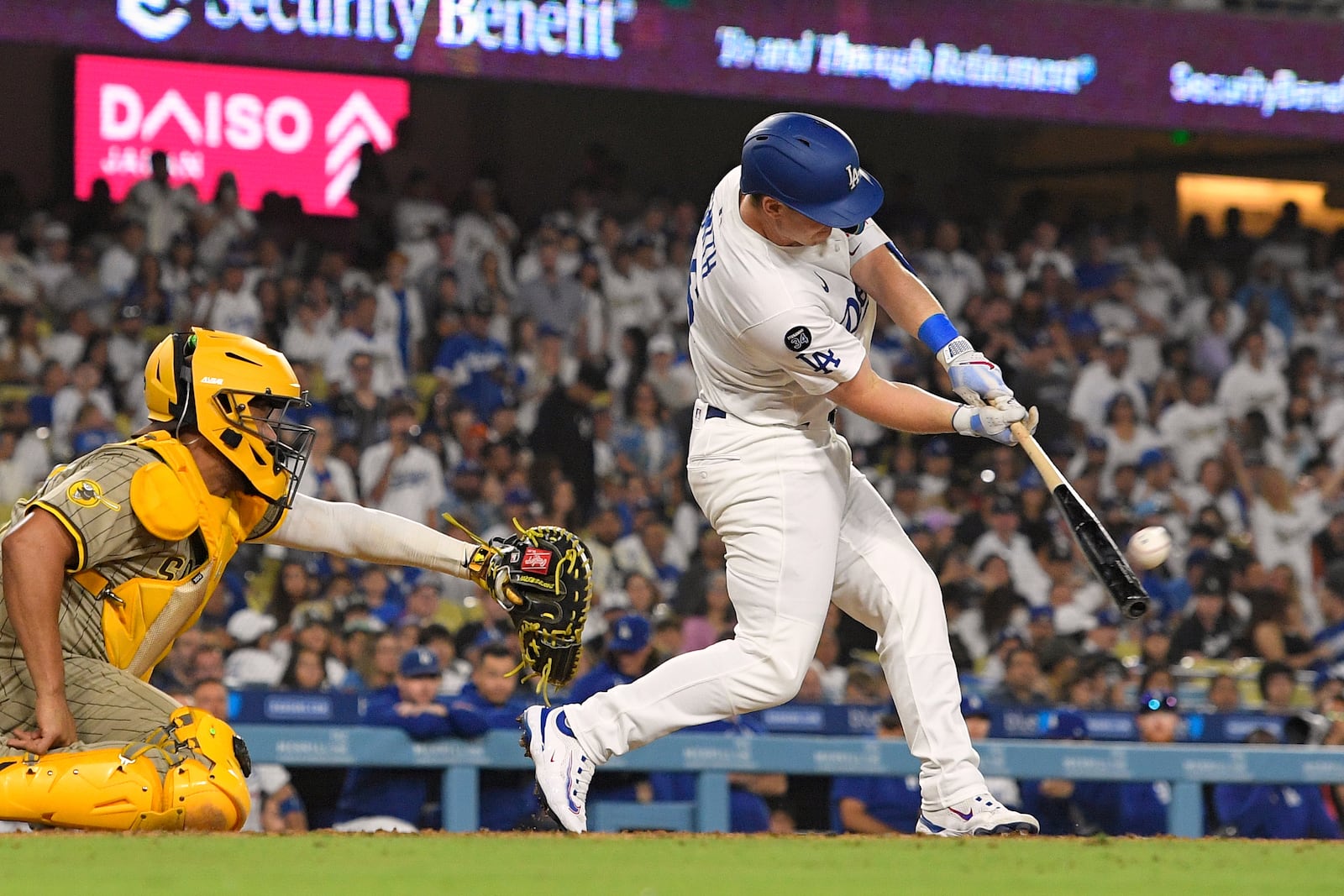 Los Angeles Dodgers' Will Smith, right, hits a walk-off home run as San Diego Padres catcher Elias Diaz watches during the ninth inning of a baseball game Wednesday, June 18, 2025, in Los Angeles. (AP Photo/Mark J. Terrill)