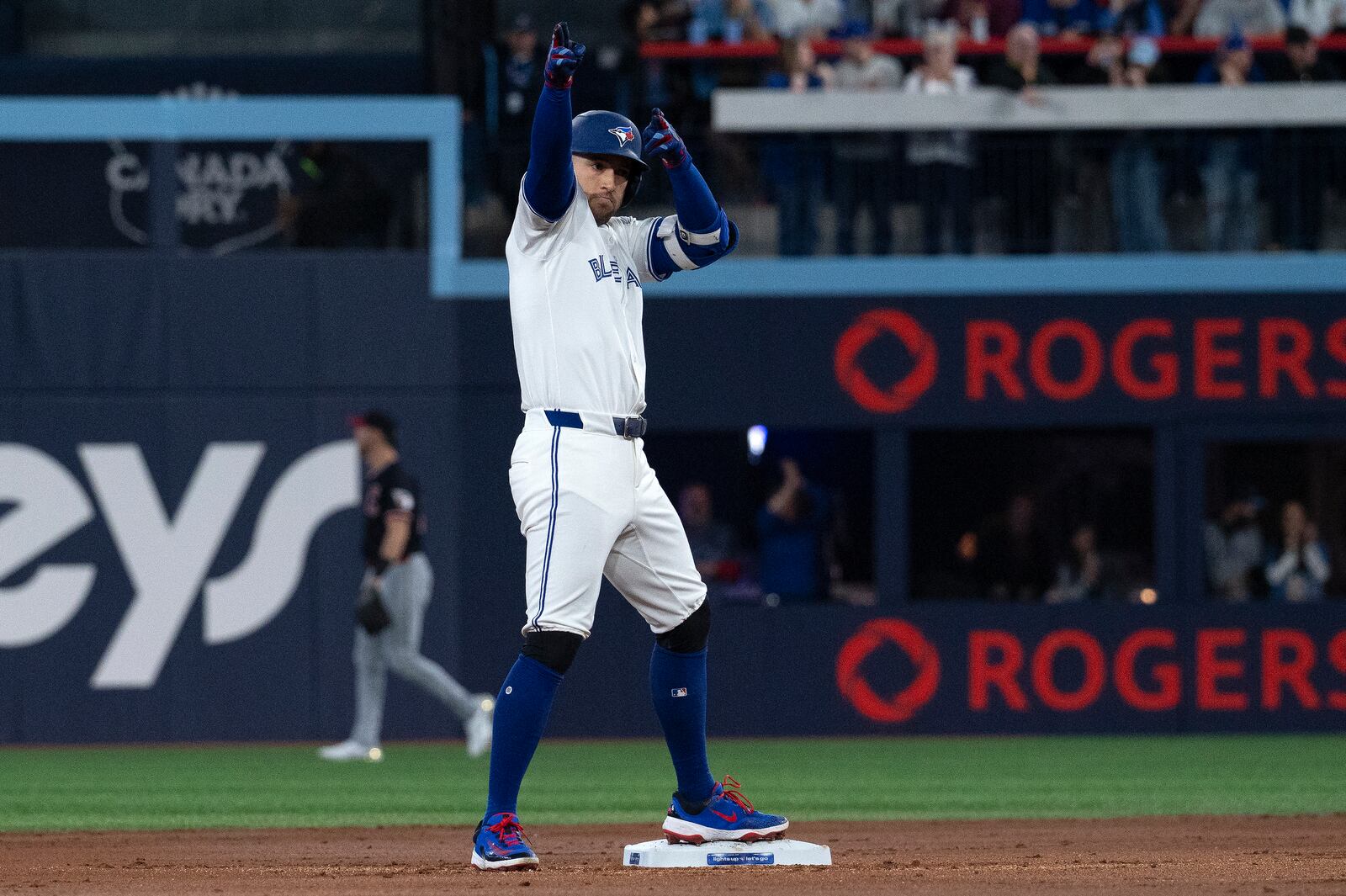 Toronto Blue Jays right fielder George Springer (4) gestures to the dugout after hitting a double against the Cleveland Guardians during the first inning of a baseball game in Toronto, Saturday, May 3, 2025. (Jon Blacker/The Canadian Press via AP)