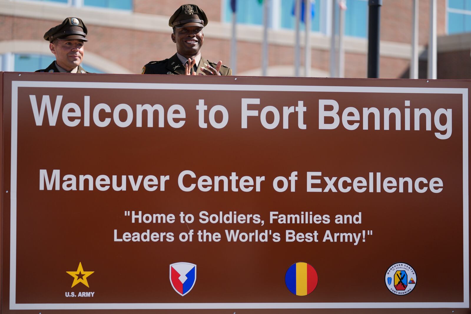 Members of the Army military stand behind a new sign at Fort Benning during a ceremony honoring new namesake on Wednesday, April 16, 2025, in Fort Benning, Ga. (AP Photo/Brynn Anderson)