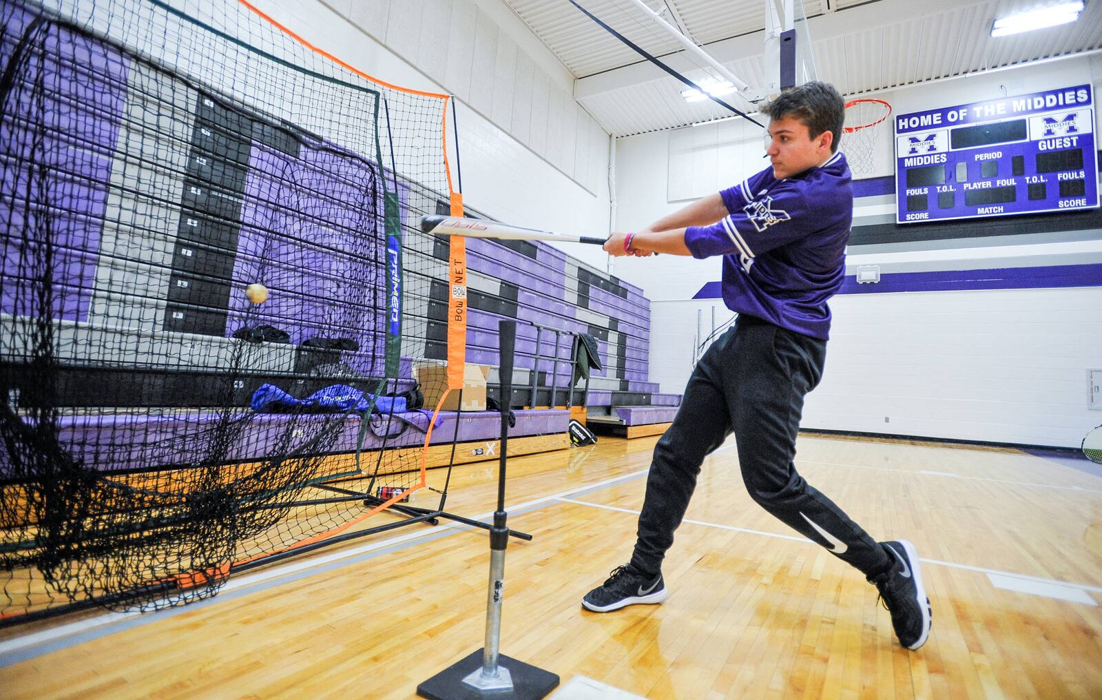 Middie baseball player Joe Current, 16, shows off his swing as Middletown Schoolsâ new middle school and high school hosted Middie XL, a district-wide open house featuring Middletown leaders, teachers and students showing off what makes the schools tick. It was a first-time experiment on a grand scale that included speeches and participation by top city officials. A wide variety of academic displays, musical performances, artistic presentations and athletic demonstrations filled the halls and classrooms. NICK GRAHAM/STAFF