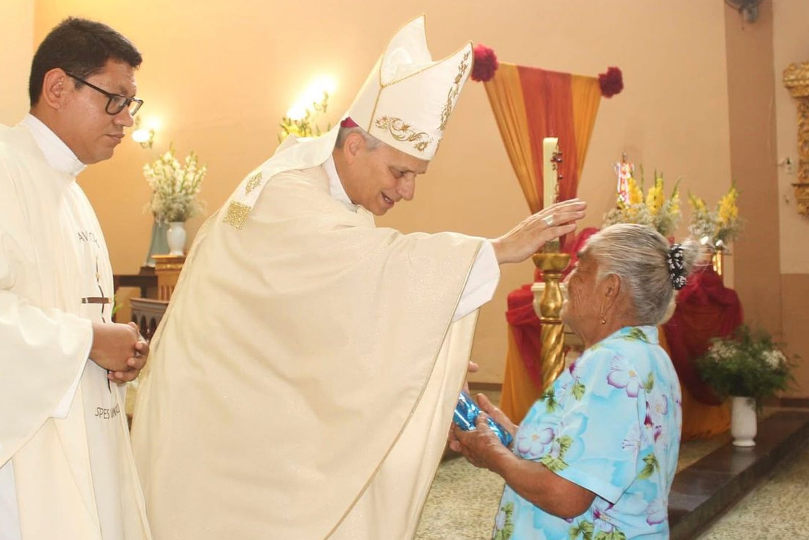 In this photo released by the Cruz de Motupe Brotherhood, Bishop Robert Prevost, who was elected Pope Leo XIV on May 8, 2025, blesses a woman during a Mass in Motupe, Peru, in September 2020. (Cruz de Motupe Brotherhood via AP)