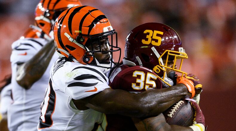 Cincinnati Bengals defensive back Brandon Wilson (40) tackles Washington Football Team running back Jaret Patterson (35) during the first half of a preseason NFL football game Friday, Aug. 20, 2021, in Landover, Md. (AP Photo/Nick Wass)