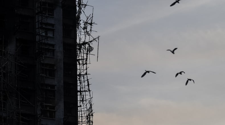 A burned building is seen at the scene of the fire that started Wednesday at Wang Fuk Court, a residential estate in the Tai Po district of Hong Kong's New Territories, Friday, Nov. 28, 2025. (AP Photo/Chan Long Hei)