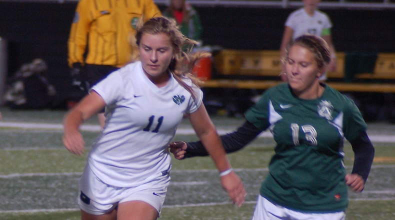 Badin’s Macy Harper (left) battles Springfield Catholic Central’s Jenna Samosky for the ball during their Division III sectional final Tuesday at Sidney. CONTRIBUTED PHOTO BY JOHN CUMMINGS