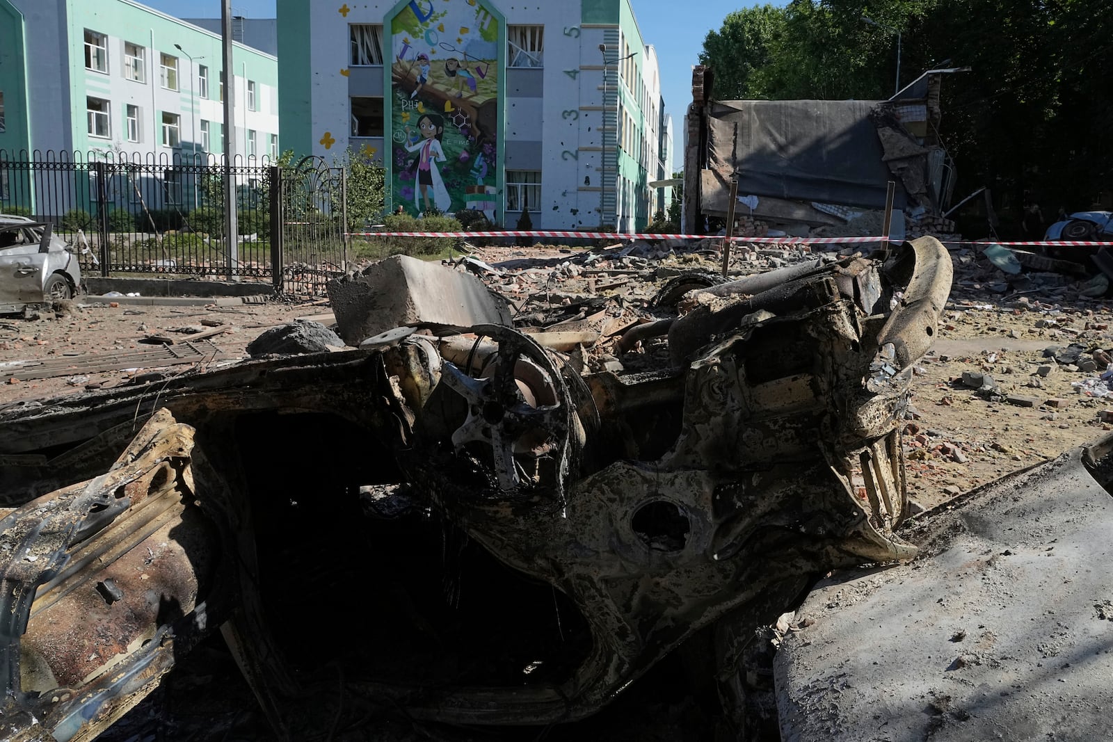 Damaged cars lie in a yard among other debris after a Russian drone and missile attacks in Kyiv, Ukraine, Friday, July 4, 2025. (AP Photo/Efrem Lukatsky)