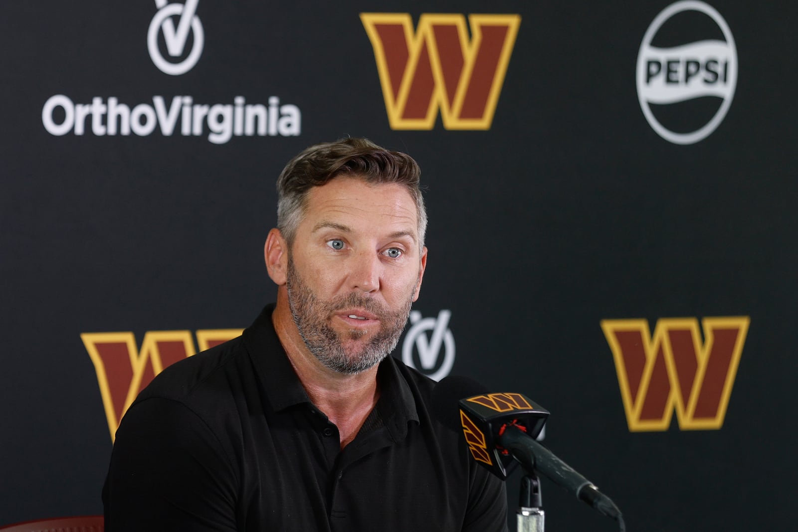 Washington Commanders general manager Adam Peters speaks during a news conference at the NFL football team's training camp in Ashburn, Va., Tuesday, July 22, 2025. (AP Photo/Luis M. Alvarez)