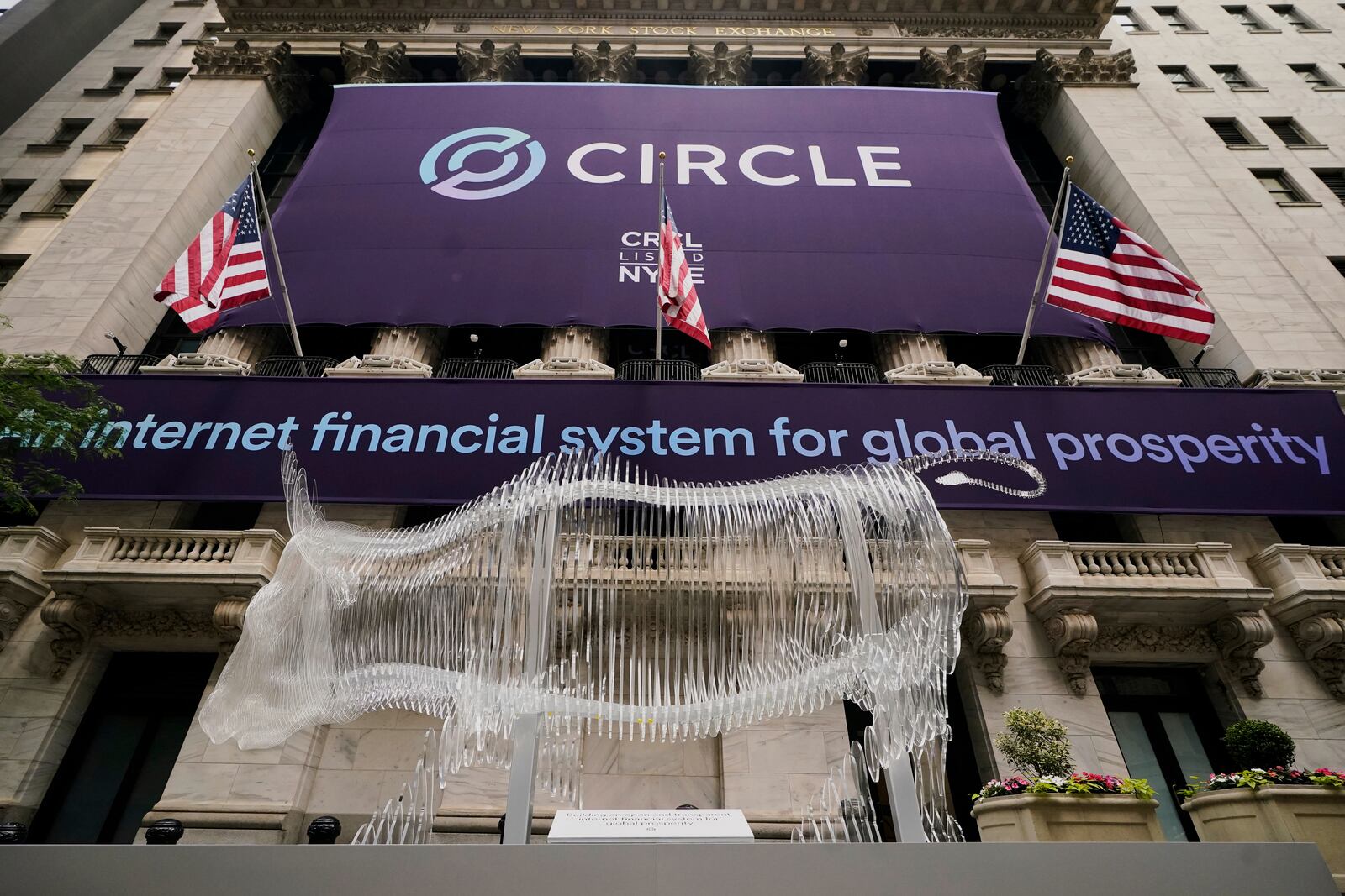 A bull sculpture is displayed outside the New York Stock Exchange for the expected Circle IPO, Thursday, June 5, 2025. (AP Photo/Richard Drew)