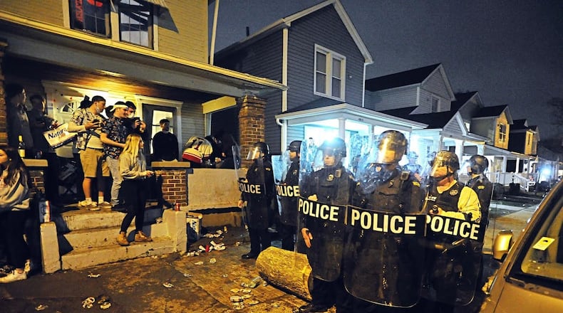 The University of Dayton Police and city of Dayton Police dispersed a large crowd of “disorderly” students Wednesday morning, March 11, 2020, during a street party where about 1,000 students gathered. Authorities say students threw bottles and damaged vehicles during the incident. MARSHALL GORBY/STAFF