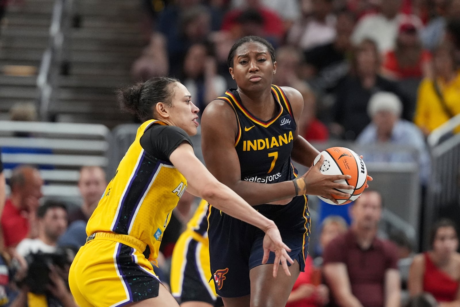 Indiana Fever's Aliyah Boston (7) is defended by Los Angeles Sparks' Dearica Hamby (5) during the second half of a WNBA basketball game, Saturday, July 5, 2025, in Indianapolis. (AP Photo/Michael Conroy)
