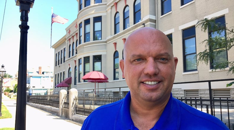 Michael Wright, director of student services for Hamilton Schools, stands in front of the district’s first-year experiment in one-stop student registration that has improved and quicken the process for new school parents. The new Central Registration At The Miami School on Ross Avenue in West Hamilton is succeeding beyond district officials’ expectations.