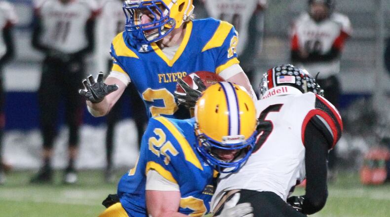 Dylan Heitkamp of Marion Local (with ball) gets a block from teammate Drandon Fleck in previous playoff action. The Flyers defeated Patrick Henry 40-6 on Saturday to earn a spot in the Division VII state championship game. MARC PENDLETON / STAFF
