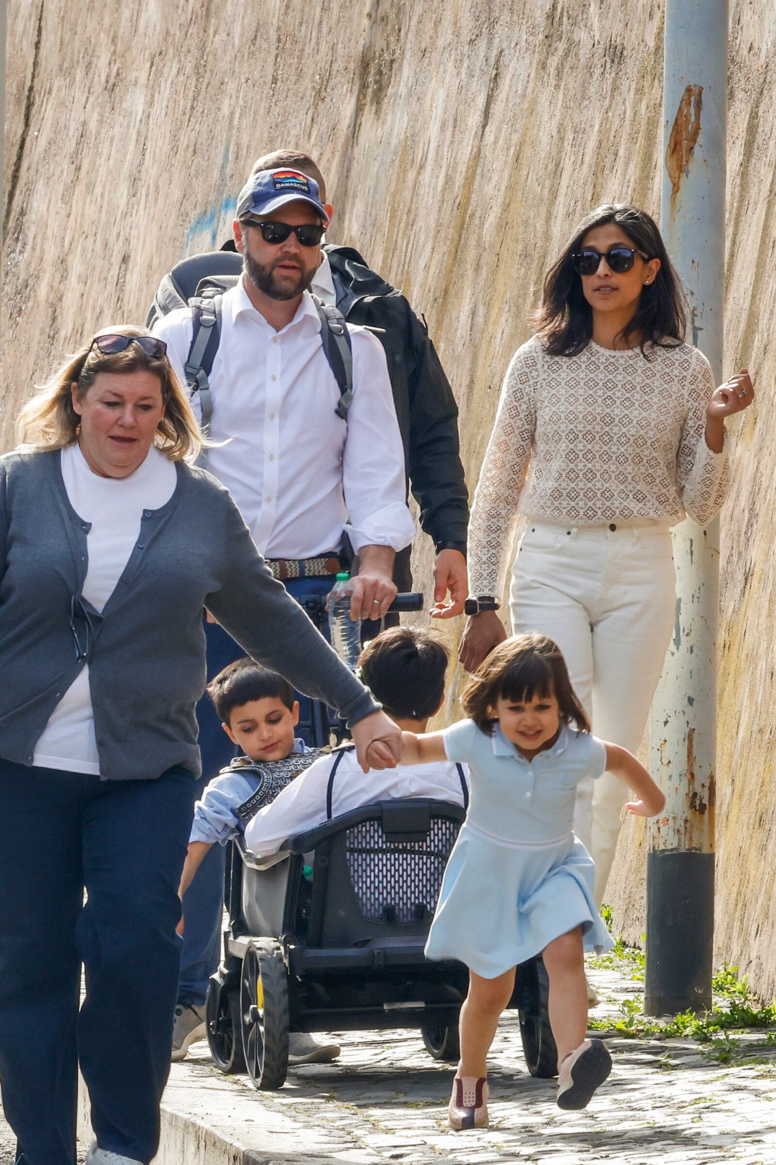 US Vice President J.D. Vance leaves Rome's Botanic Gardens with his wife Usha, right, their daughter Mirabel holding hand with an unidentified staff, front, and sons Vivek and Ewan, back to camera, Saturday, April 19, 2025. (AP Photo/Riccardo De Luca)