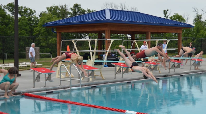 FILE: The Oxford Swimming and Diving team take part in the first lap in the new competition pool at the Oxford Aquatic Center. CONTRIBUTED/BOB RATTERMAN