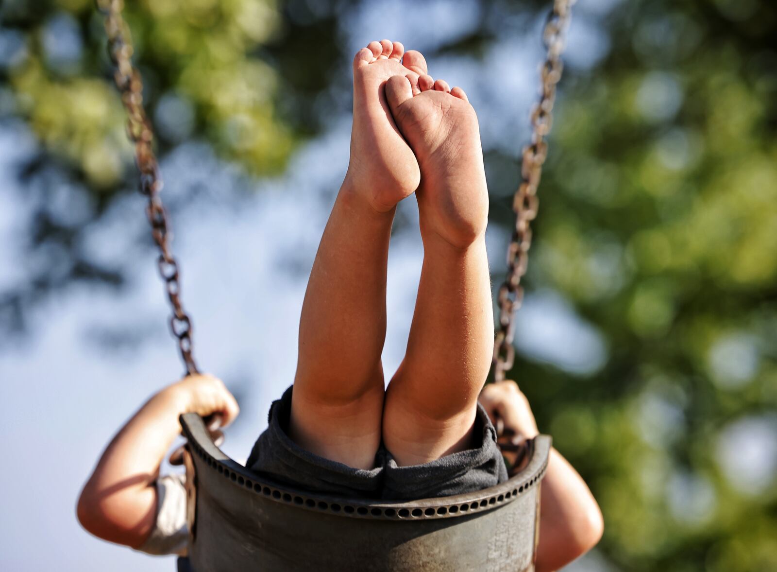 Drew Puckett, 3, plays at a park Thursday, Aug. 26, 2021 in Hanover Township. Puckett was treated by Shriner's Children's Ohio for severe burns to his feet last year after he walked through hot coals that remained after a campfire. NICK GRAHAM / STAFF