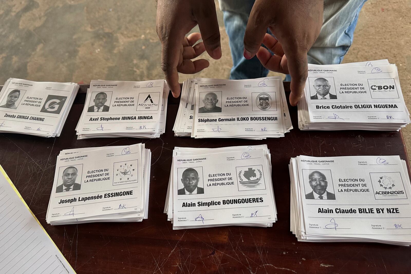 Ballots for presidential candidates are placed on a table inside a polling station, in Liberville, Gabon, Saturday, April 12, 2025. (AP Photo/Betines Makosso)
