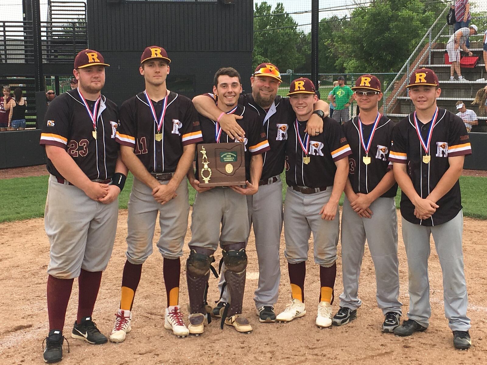 Ross coach Jason Rettinger poses with his seniors — from left, Logan Fuller, Montana Allgaier, Andrew Beebe, Brock Tatum, Zach King and Clay Maggard — after Monday’s 6-3 victory over Tippecanoe in a Division II district championship game at Mason. RICK CASSANO/STAFF