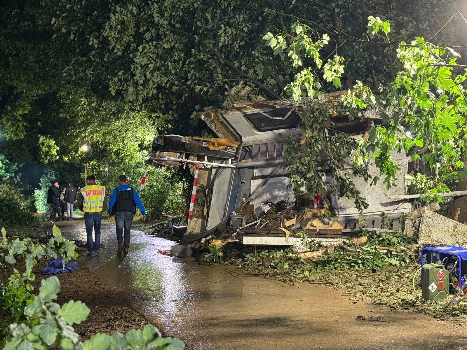 Parts of the derailed regional passenger train lie next to a section of track as police and first responders work at the scene near Riedlingen, Germany, Sunday, July 27, 2025. (Nico Pointner/dpa via AP)