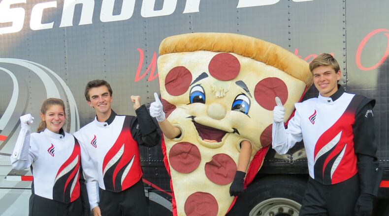 UNO Pizzeria and Grill in West Chester Twp. will once again host a fundraiser for the Lakota West Marching Band, this time to help with the group’s costs for a performance at Disney World’s Magic Kingdom on New Year’s Eve. Pictured are Lakota West Marching Firebird band members Rachel Pizzuco, Nick Linder, Nathan Simon (in the pizza costume), and Christian Bogard. CONTRIBUTED