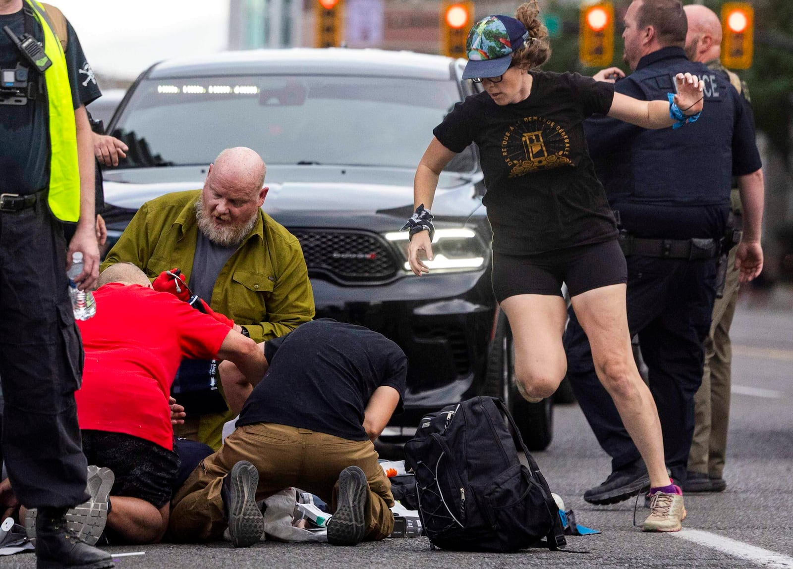 People rush to give medical assistance to a man shot during a “No Kings” protest in Salt Lake City on Saturday, June 14, 2025. (Brice Tucker//The Deseret News via AP)