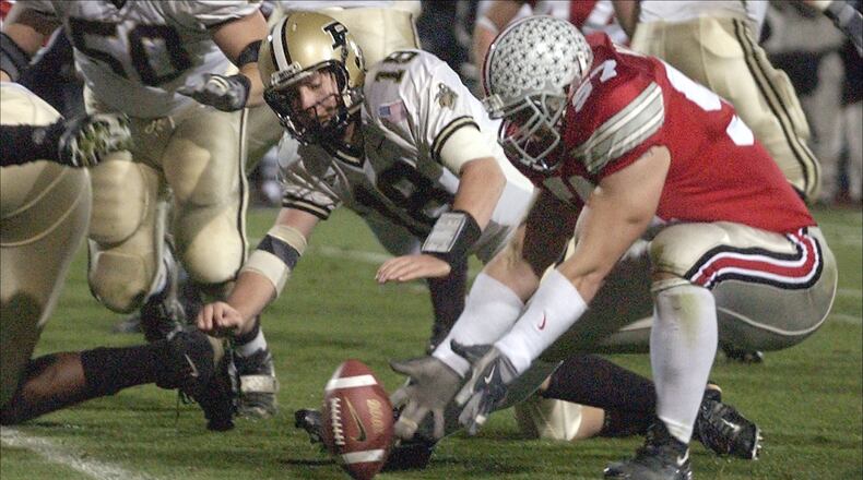 COLUMBUS, OH - NOVEMBER 15: Mike Kudla #57 of the Ohio State Buckeyes recovers a fumble by quarterback Kyle Orton #18 of the Purdue Boilermakers for a touchdown during the fourth quarter on November 15, 2003 at Ohio Stadium in Columbus, Ohio. Ohio State defeatede Purdue 16-13. (Photo by David Maxwell/Getty Images)