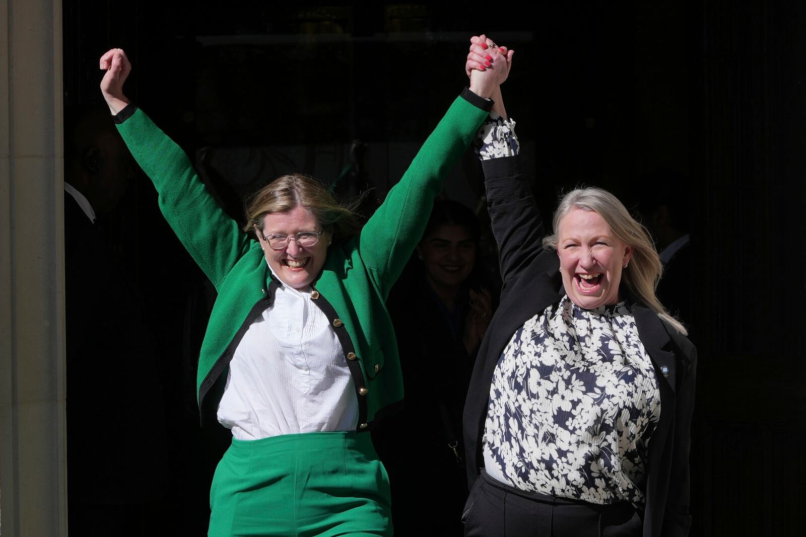 Marion Calder and Susan Smith from For Women Scotland, celebrate outside the Supreme Court to challenge gender recognition laws, in London, Wednesday, April 16, 2025. (AP Photo/Kin Cheung)